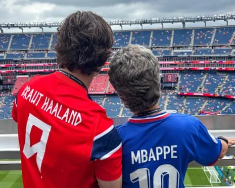 Fans inside the ground with shirts of Erling Haaland and Kylian Mbappé